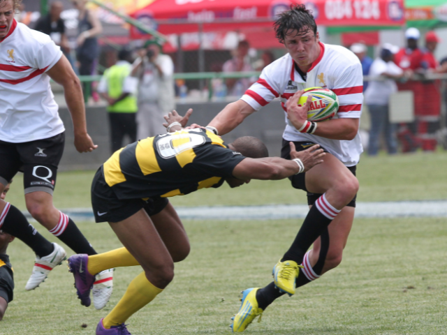 Rugby player dodging a tackle during a fast-paced match.