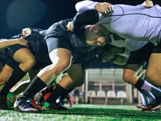 Rugby teams in a scrum formation, preparing to engage in a match. (Rugby Union and Tag Rugby)