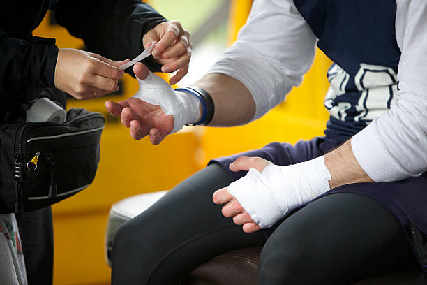 A player’s hands getting taped up for extra support and protection during the game.