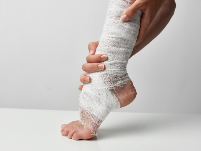 Close-up of a foot wrapped in gauze after an injury.