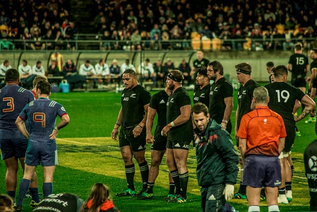 rugby players standing on the field