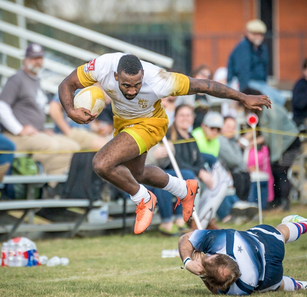 player holding a rugby ball