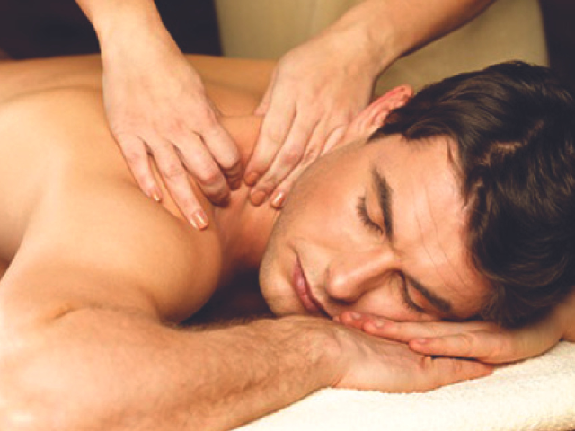 A man receiving a professional back massage for muscle recovery.