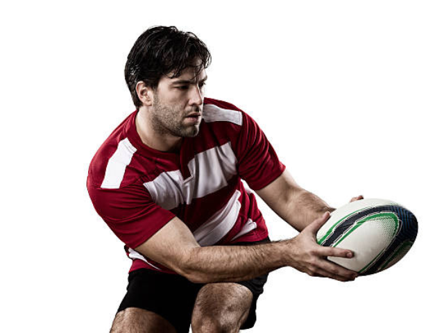 Rugby player in a red and white jersey preparing to pass the ball.