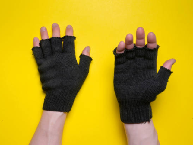 Two hands wearing black fingerless gloves against a bright yellow background.