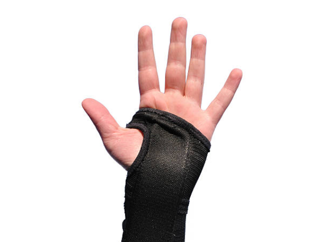 Raising hand wearing rugby grip mitts.