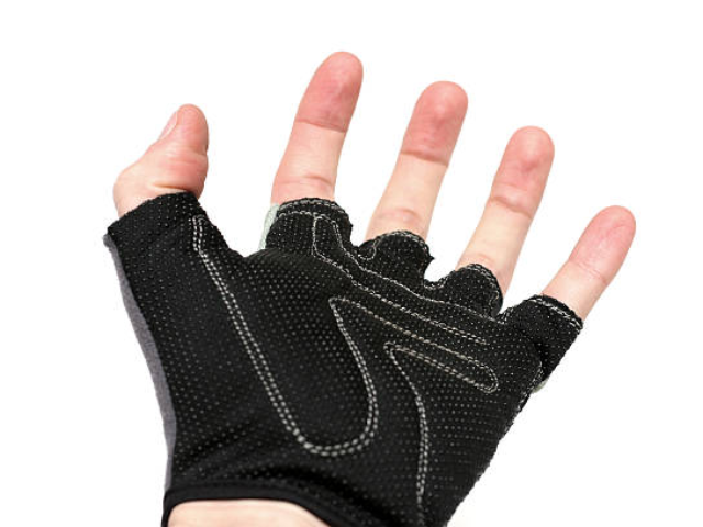 A close-up of the inside palm of a half-finger glove, showing its textured grip design.