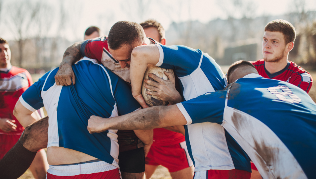 A close-up of rugby players forming a scrum, with intense focus on the ball.