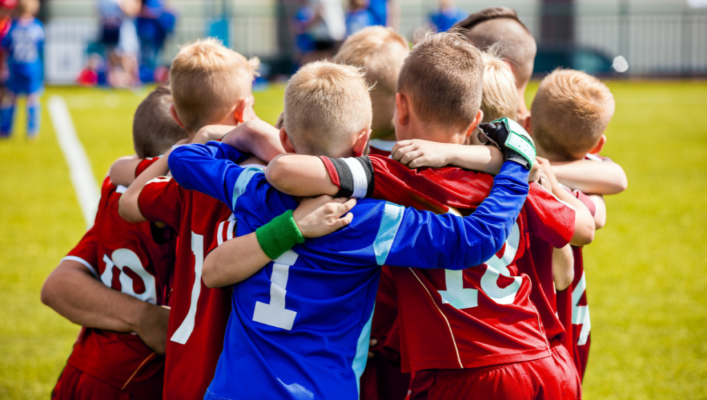 Youth rugby players huddling before a match, showing team spirit.