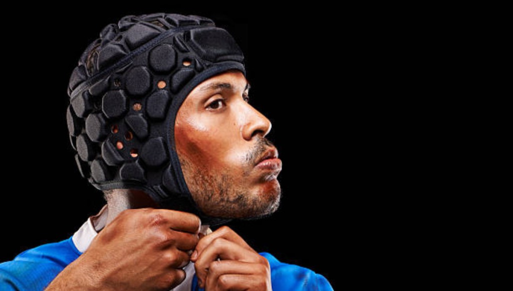 A player adjusting his scrum cap before the game.