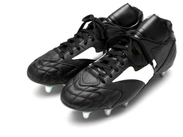 Classic black and white rugby boots with metal studs for traction.